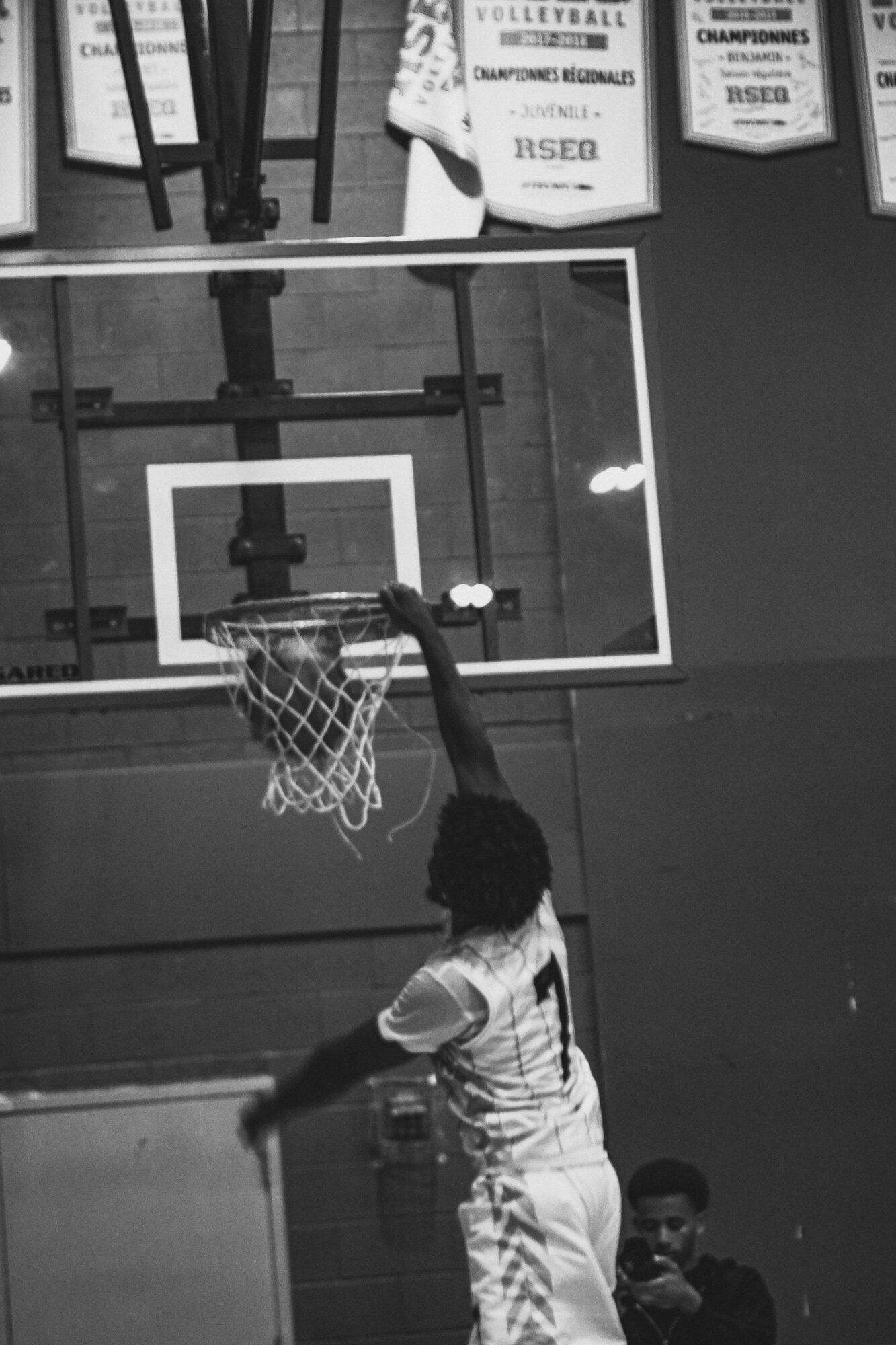 Black and white action shot of a player dunking