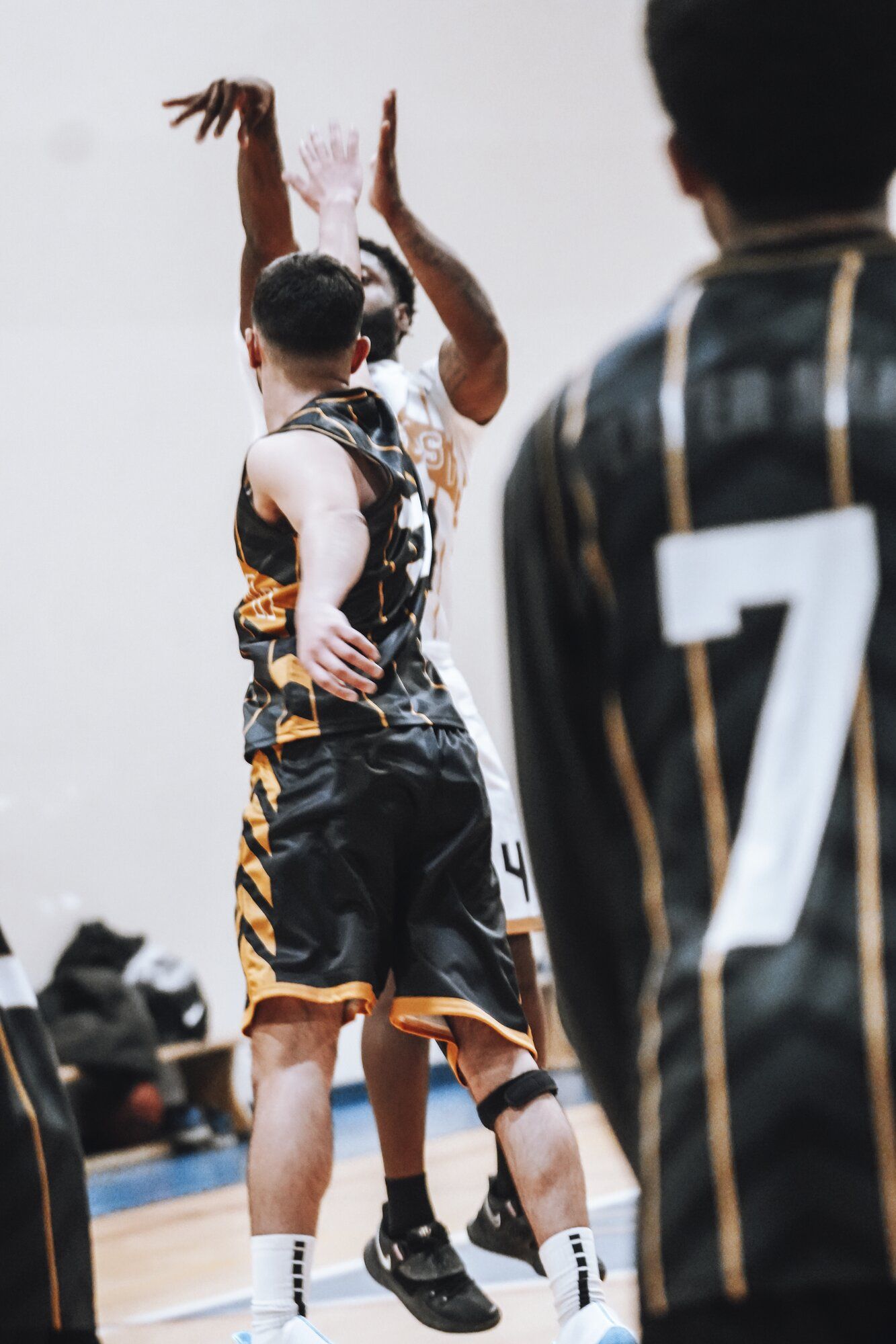Player taking a jump shot during a game